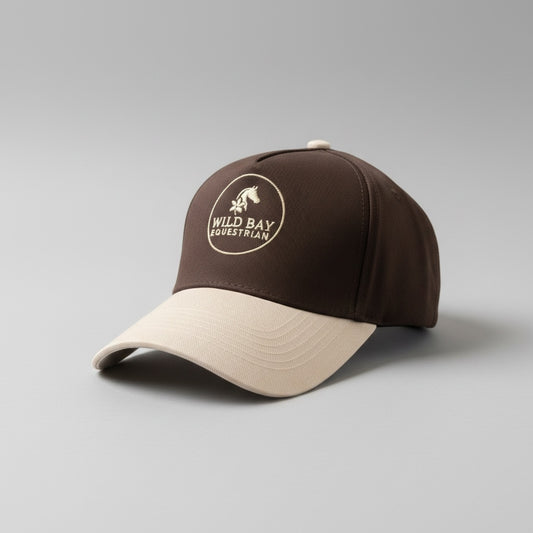 Wild Bay Equestrian two-tone baseball cap in brown and cream with embroidered logo on a grey background